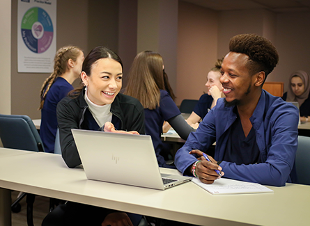 Two people at a laptop