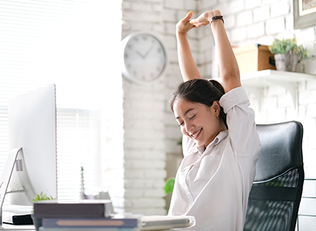 Woman stretching at desk